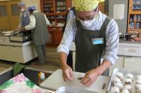 ライスペーパーに先程の中身をのせて包んでいる